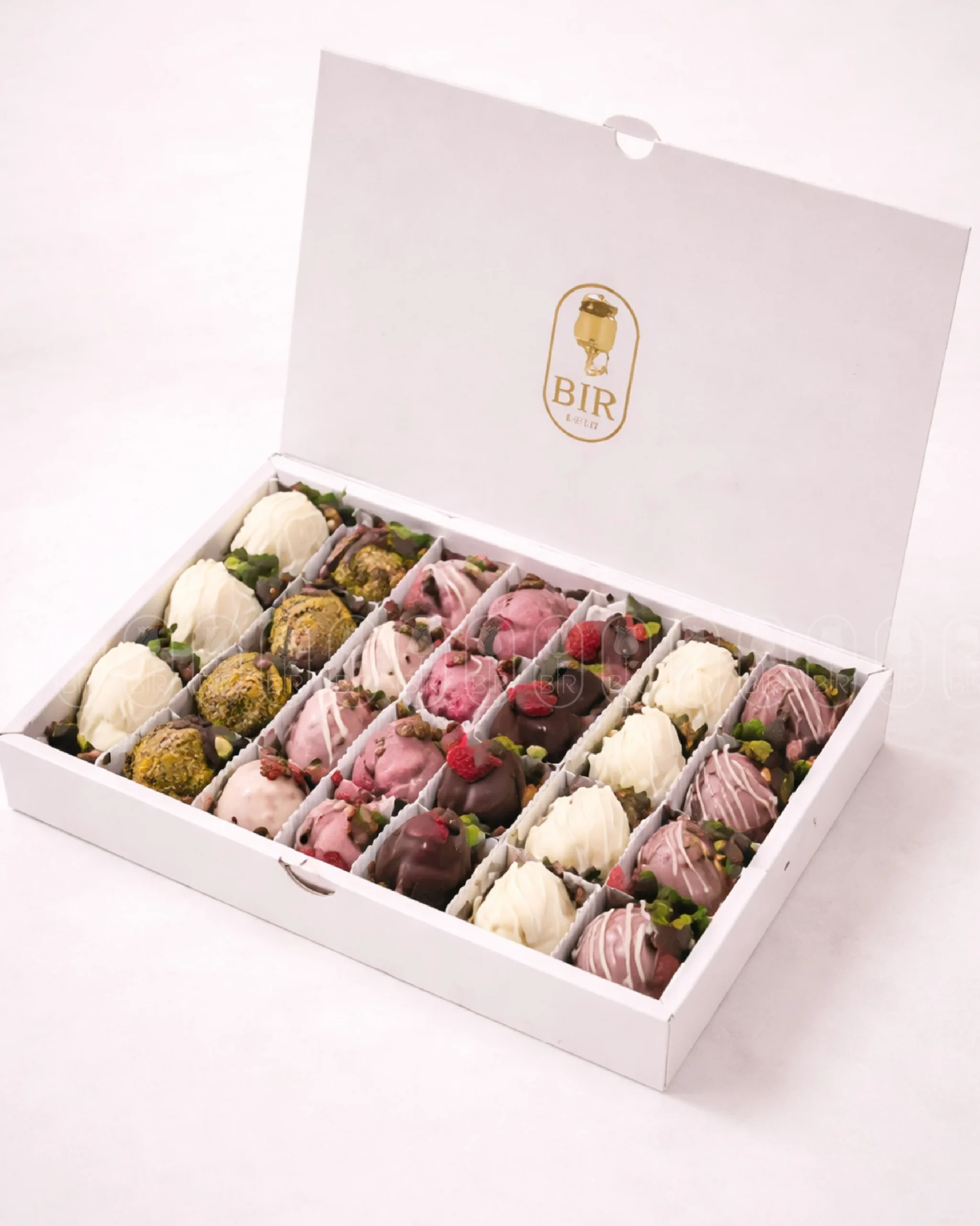 Luxury box of mixed chocolate-dipped strawberries with dark, white, milk, and pink chocolate varieties
