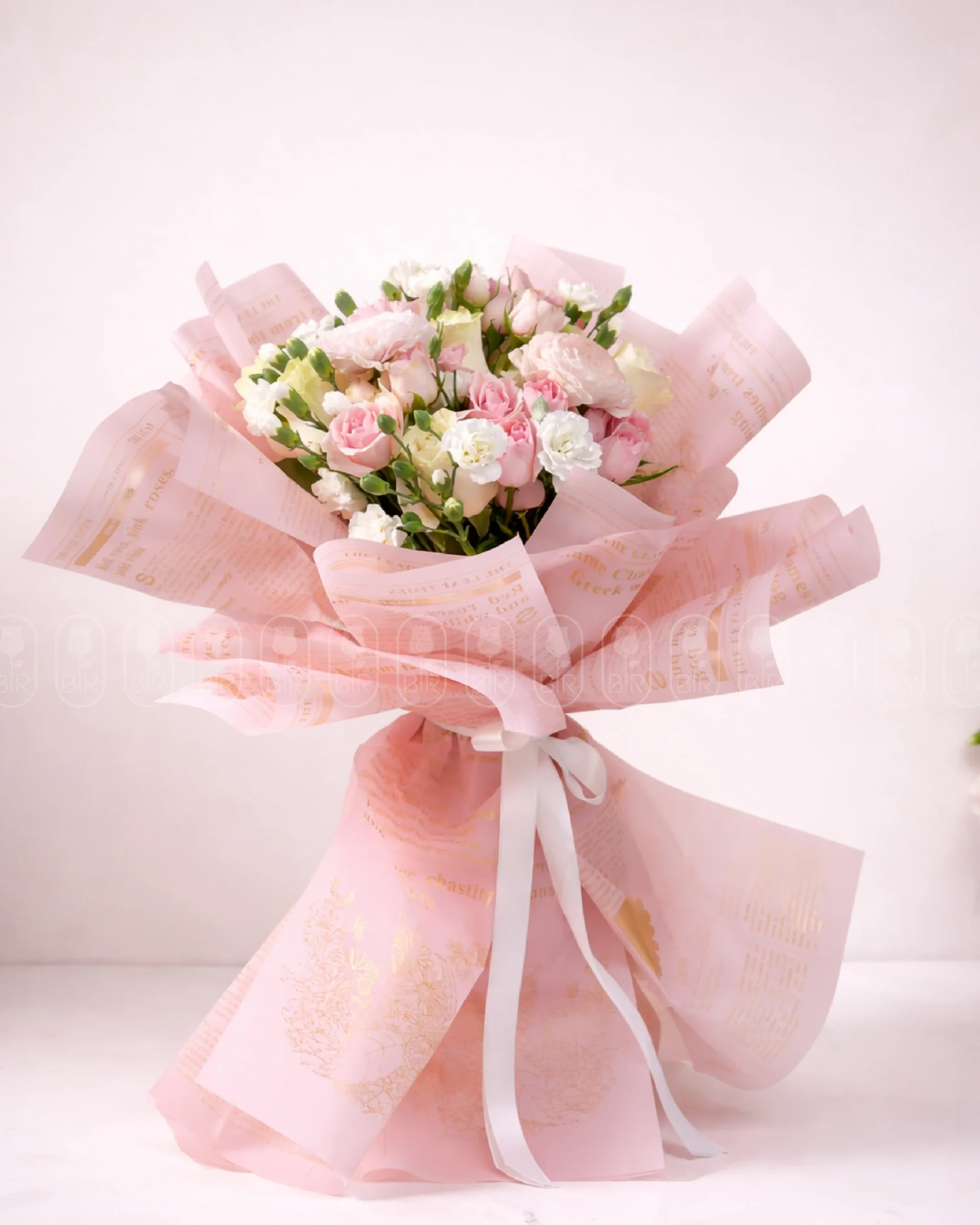 Elegant pink floral bouquet with soft pastel flowers beautifully wrapped in luxury pink paper