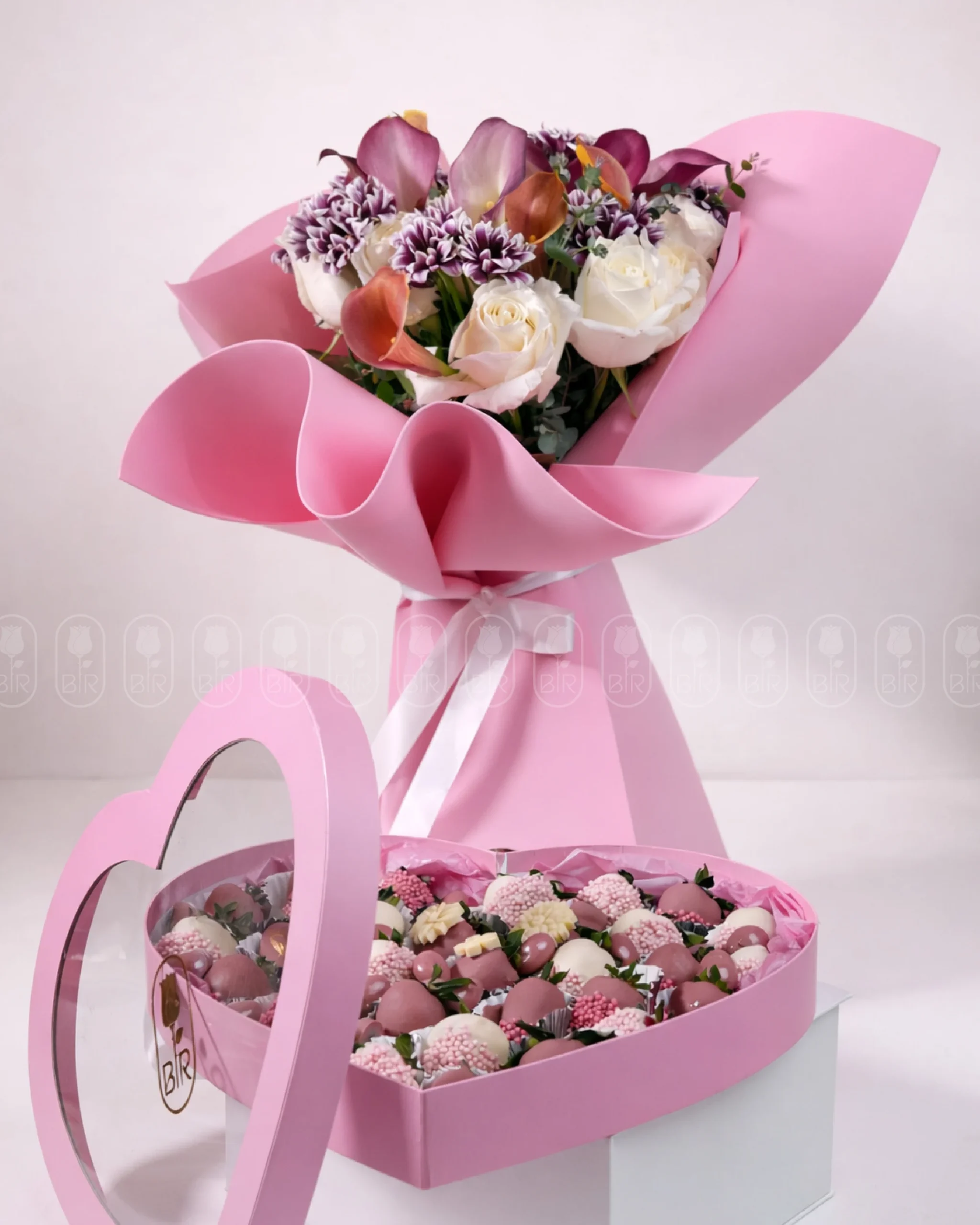 Luxury flower bouquet with heart box of Belgian chocolate-dipped strawberries in elegant pink gift arrangement
