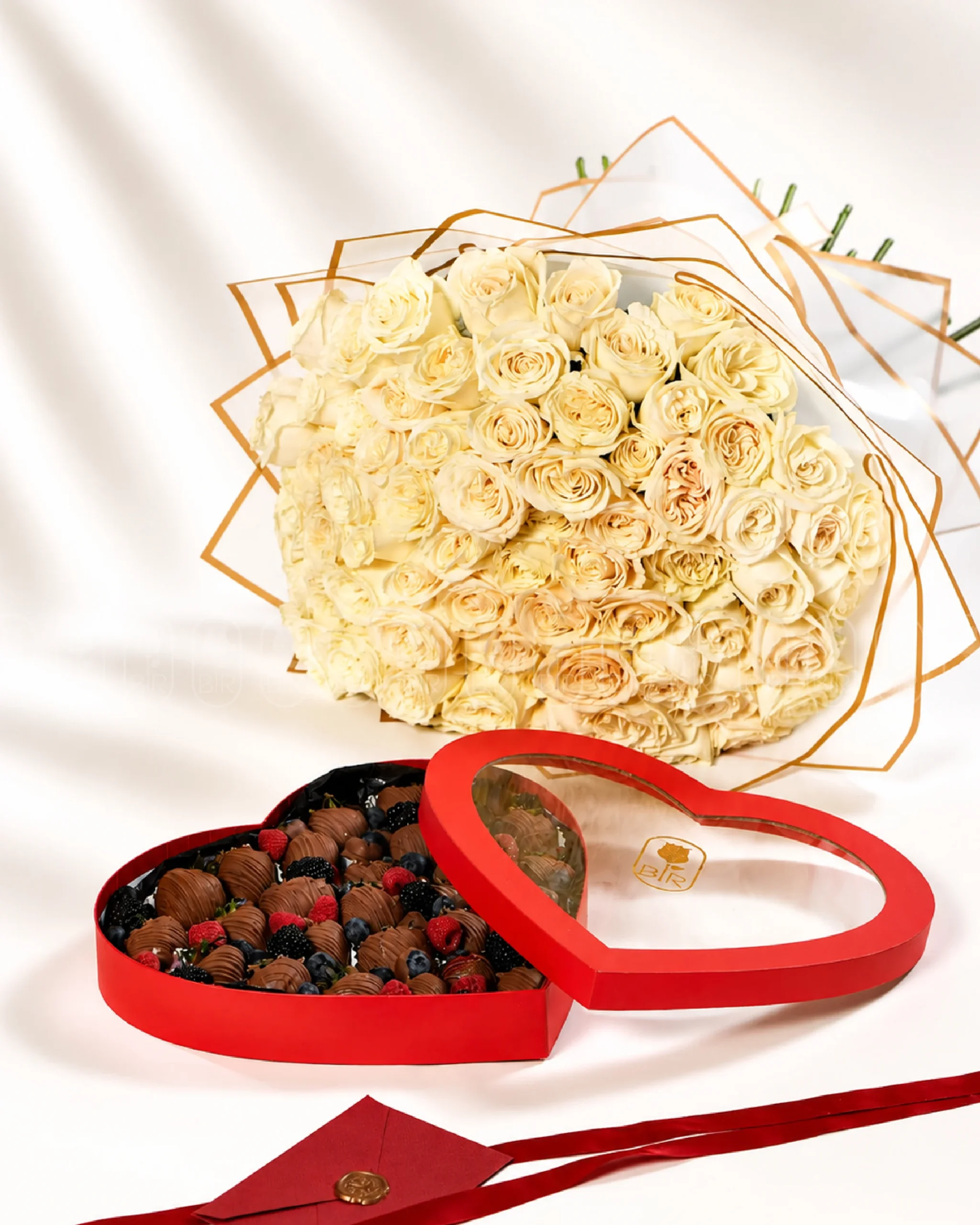 Luxury bouquet of 100 ivory roses with heart-shaped Belgian chocolate strawberry box