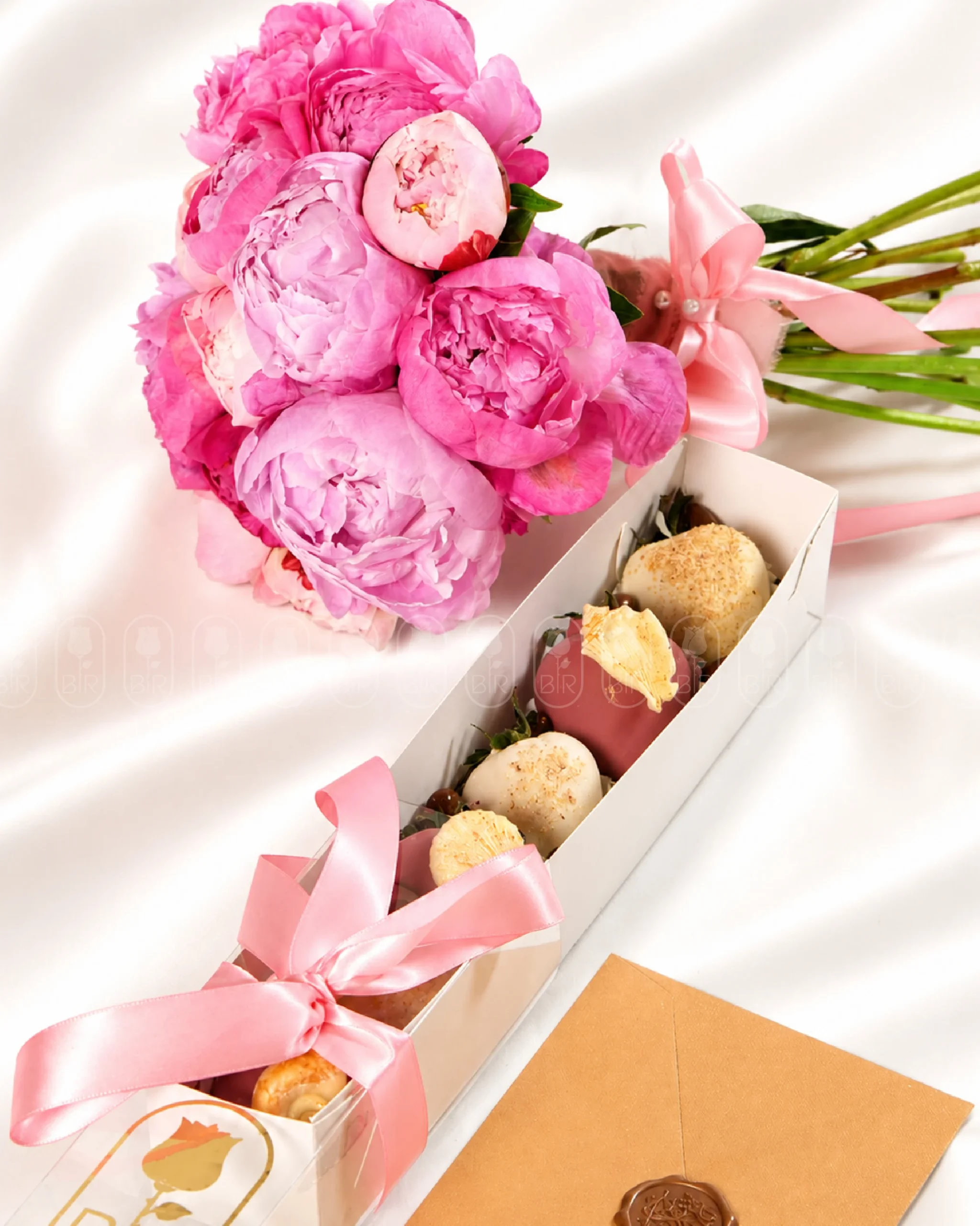 Pink peony bouquet with chocolate-covered strawberries and pink ribbon