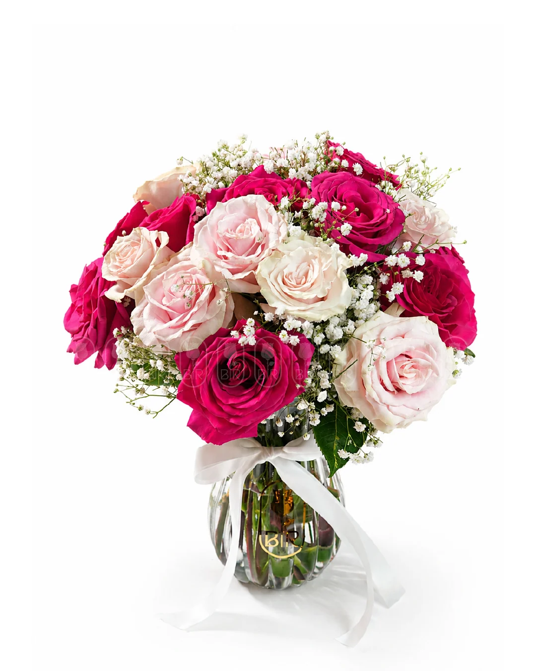 Pink and white rose bouquet with baby’s breath in a glass vase
