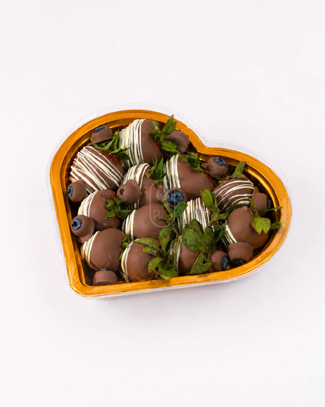 Heart-shaped tray of Belgian chocolate covered strawberries with blueberries