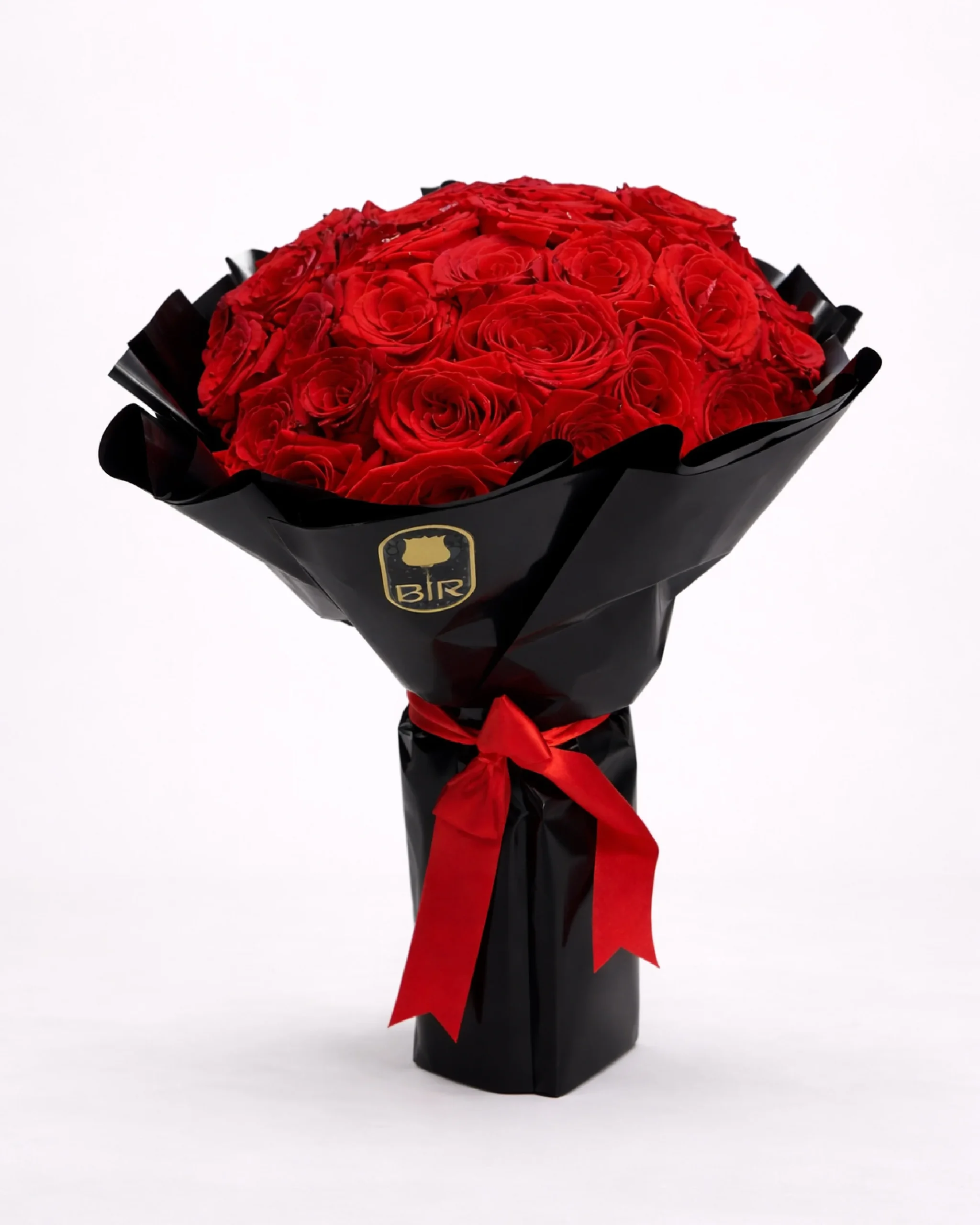 Luxurious bouquet of 75 red roses wrapped in black paper with red ribbon