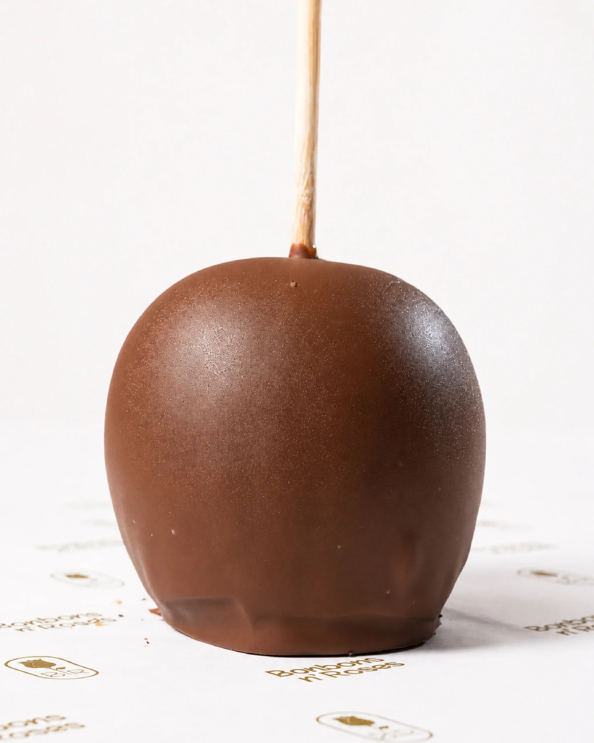 Classic handcrafted caramel apple dipped in smooth premium milk chocolate with a rich glossy finish.
