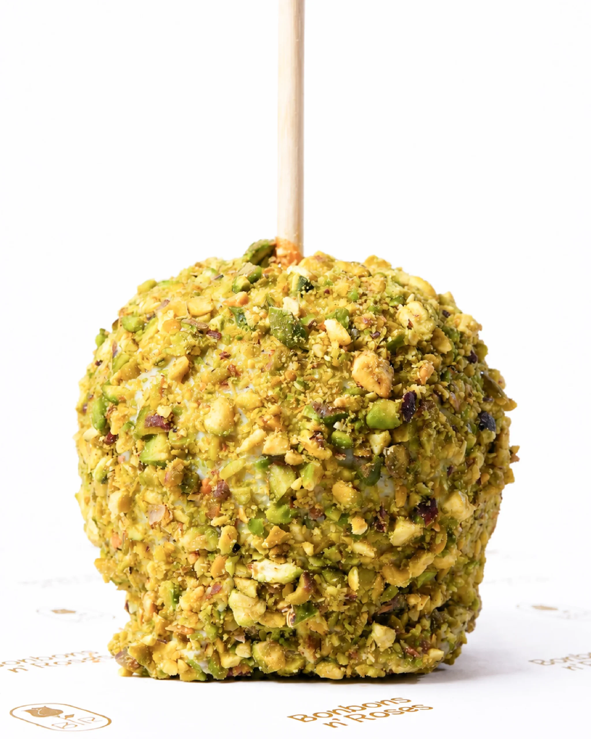 Handcrafted caramel apple coated with premium white chocolate and crunchy roasted pistachios